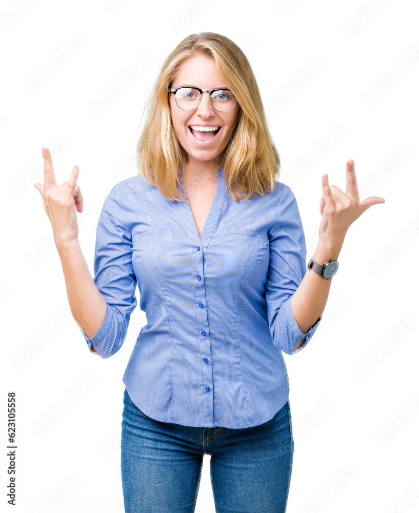 Beautiful young business woman over isolated background shouting with crazy expression doing rock symbol with hands up. Music star. Heavy concept.
