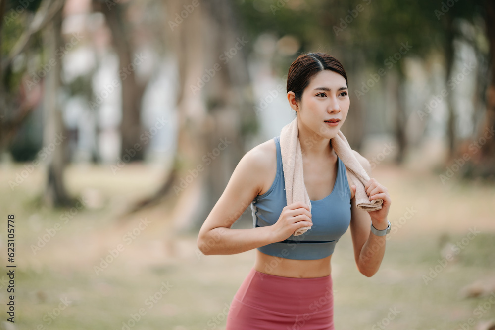 Young sporty woman running in green park.Sport lifestyle. Motion blur. in sun light Young sporty woman running in green park.Sport lifestyle. Motion blur. in sun light
