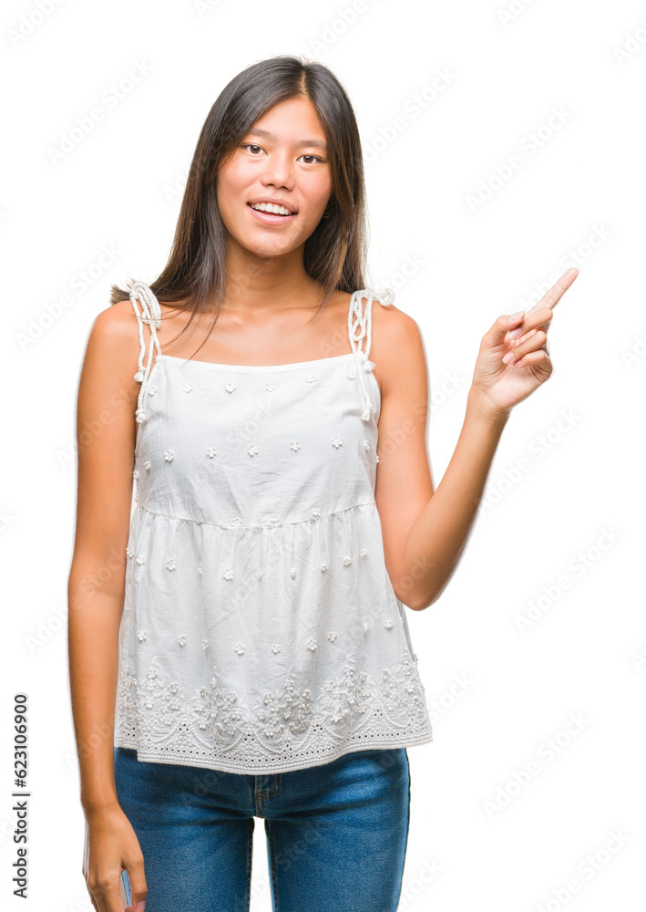 Young asian woman over isolated background with a big smile on face, pointing with hand and finger to the side looking at the camera. Young asian woman over isolated background with a big smile on face, pointing with hand and finger to the side looking at the camera.