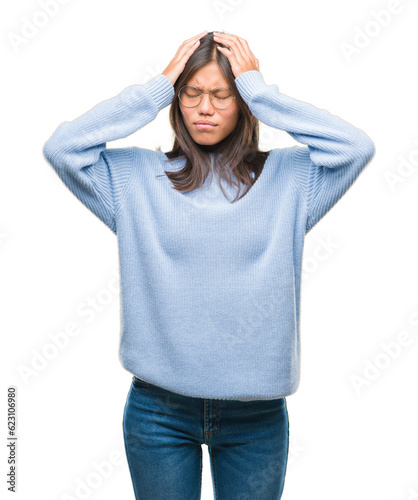 Quadro em tela Young asian woman wearing winter sweater over isolated background suffering from headache desperate and stressed because pain and migraine