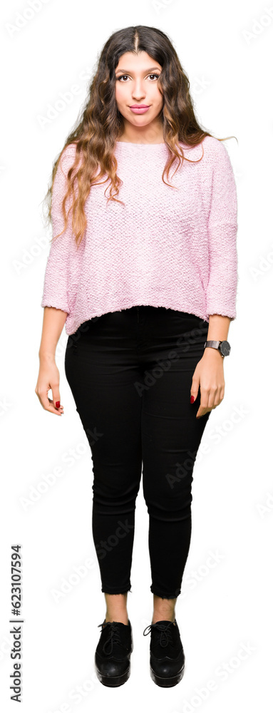 Fototapeta premium Young beautiful woman wearing pink sweater Relaxed with serious expression on face. Simple and natural looking at the camera.