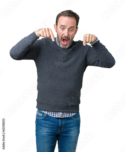 Handsome middle age senior man wearing a sweater over isolated background Pointing down with fingers showing advertisement, surprised face and open mouth