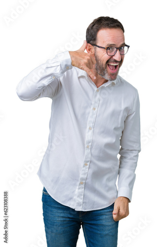 Handsome middle age elegant senior business man wearing glasses over isolated background smiling doing phone gesture with hand and fingers like talking on the telephone. Communicating concepts.