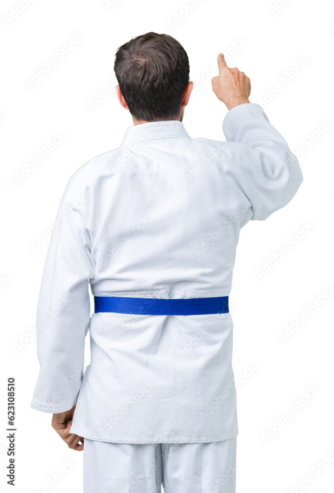 Handsome middle age senior man wearing kimono uniform over isolated background Posing backwards pointing behind with finger hand Handsome middle age senior man wearing kimono uniform over isolated background Posing backwards pointing behind with finger hand