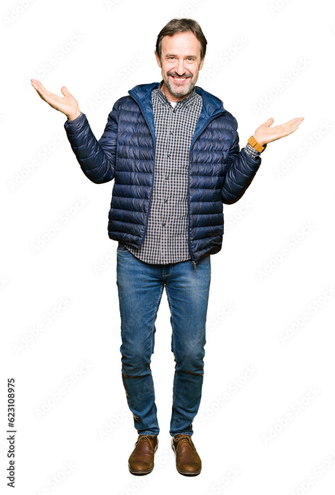 Middle age handsome man wearing winter coat Smiling showing both hands open palms, presenting and advertising comparison and balance Middle age handsome man wearing winter coat Smiling showing both hands open palms, presenting and advertising comparison and balance