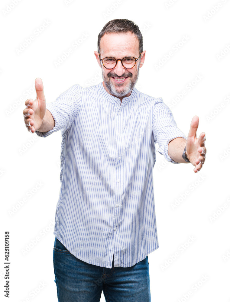 Middle age hoary senior man wearing glasses over isolated background looking at the camera smiling with open arms for hug. Cheerful expression embracing happiness. Middle age hoary senior man wearing glasses over isolated background looking at the camera smiling with open arms for hug. Cheerful expression embracing happiness.