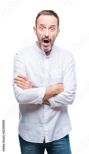 Middle age hoary senior man over isolated background afraid and shocked with surprise expression, fear and excited face. © Krakenimages.com