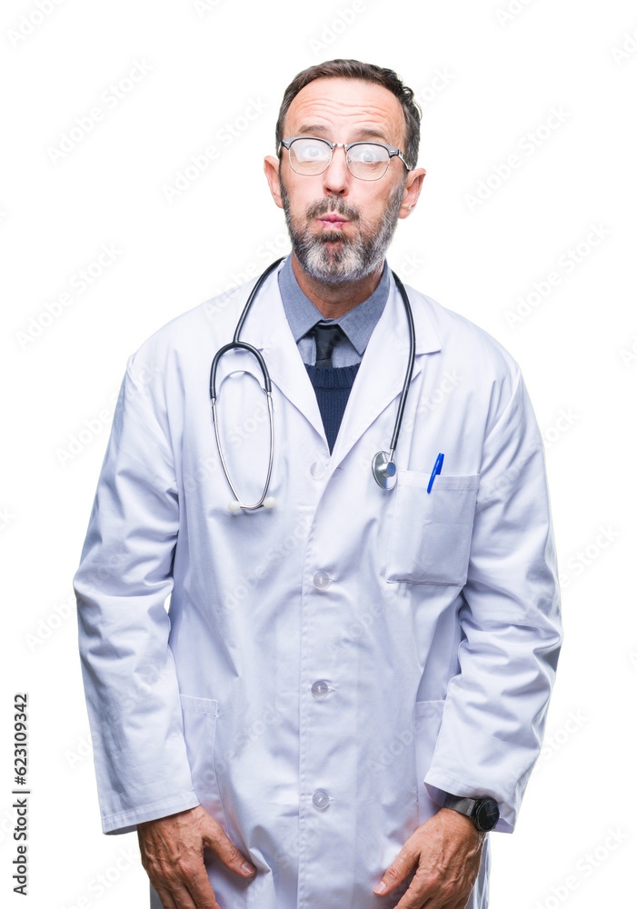 Middle age senior hoary doctor man wearing medical uniform isolated background puffing cheeks with funny face. Mouth inflated with air, crazy expression.