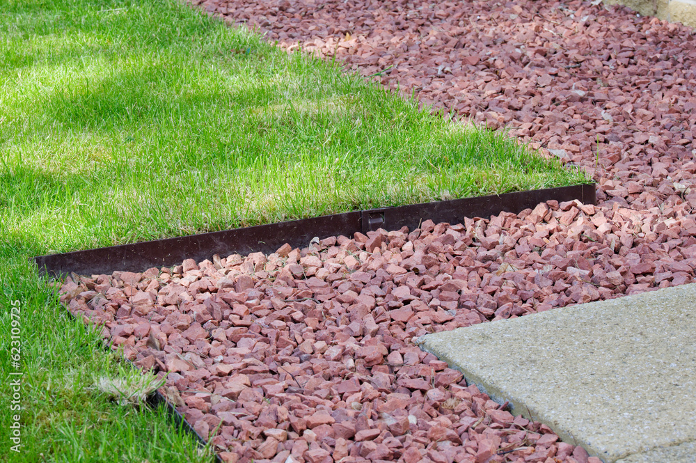 Lawn edging made of metal showing straight and neat finish - obrazy, fototapety, plakaty 