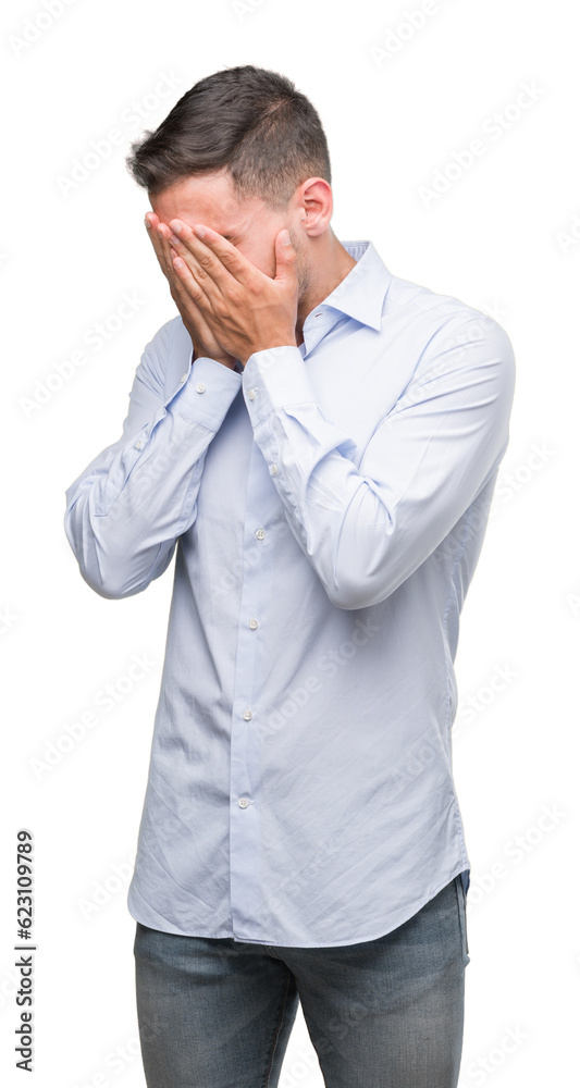 Handsome young businessman with sad expression covering face with hands while crying. Depression concept. Handsome young businessman with sad expression covering face with hands while crying. Depression concept.