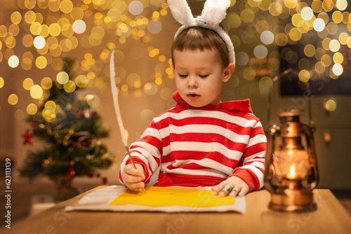 little boy writes a letter to Santa Claus