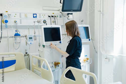 Intensive care unit in hospital, bed with monitors, ventilator, hospital ward