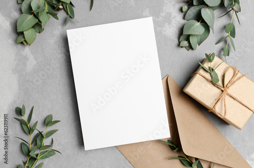 Greeting card mockup with gift box, envelope and eucalyptus plant