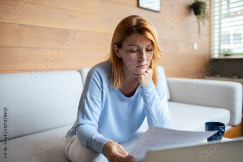 Mid adult woman going over bills at home