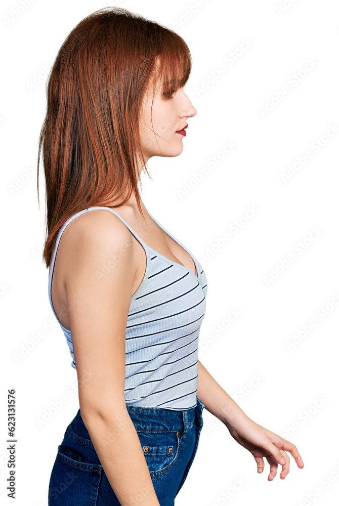 Redhead young woman wearing casual style with sleeveless shirt looking to side, relax profile pose with natural face with confident smile. Redhead young woman wearing casual style with sleeveless shirt looking to side, relax profile pose with natural face with confident smile.