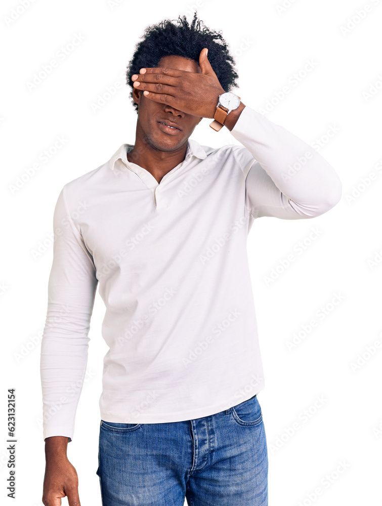 Handsome african american man with afro hair wearing casual clothes and glasses covering eyes with hand, looking serious and sad. sightless, hiding and rejection concept Handsome african american man with afro hair wearing casual clothes and glasses covering eyes with hand, looking serious and sad. sightless, hiding and rejection concept