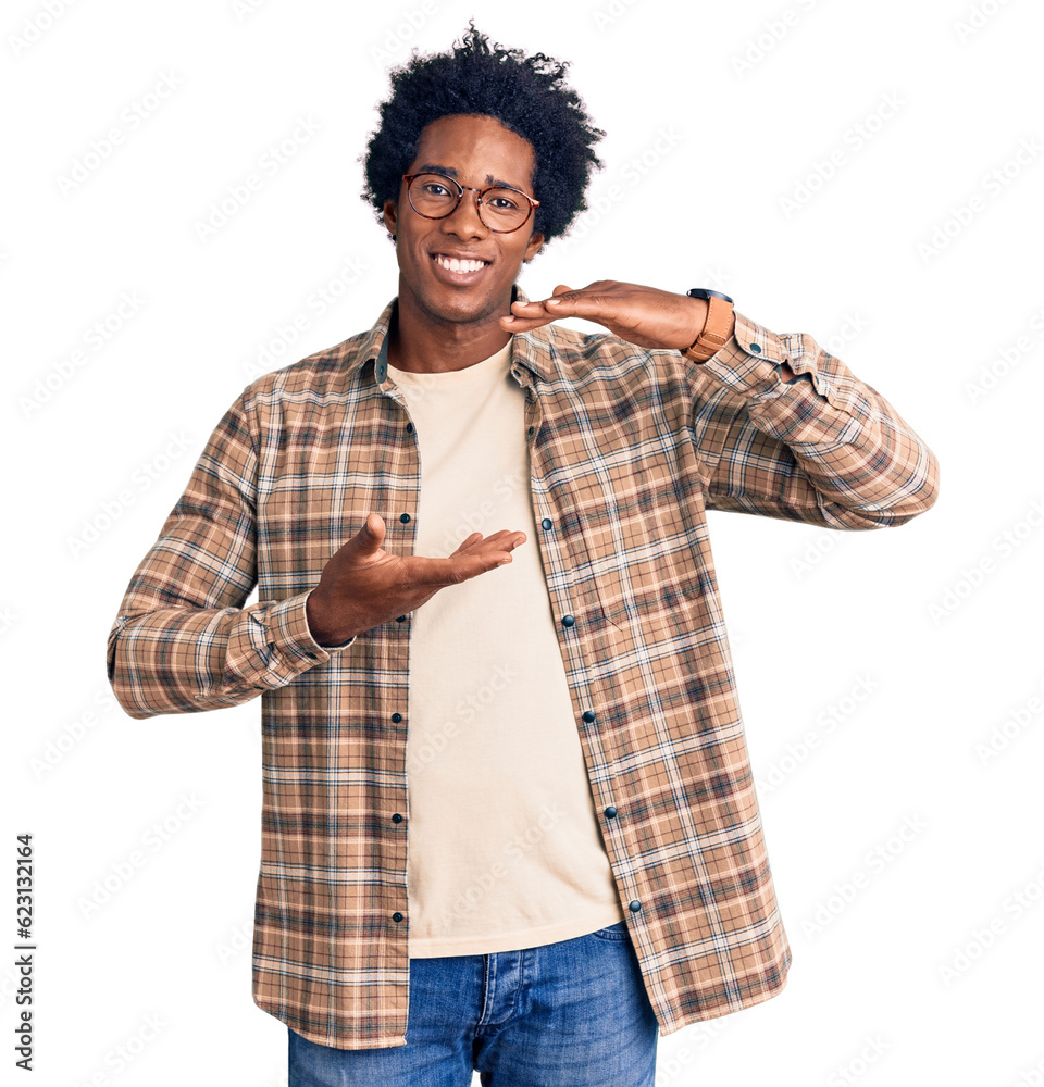 Handsome african american man with afro hair wearing casual clothes and glasses gesturing with hands showing big and large size sign, measure symbol. smiling looking at the camera. measuring concept. Handsome african american man with afro hair wearing casual clothes and glasses gesturing with hands showing big and large size sign, measure symbol. smiling looking at the camera. measuring concept.