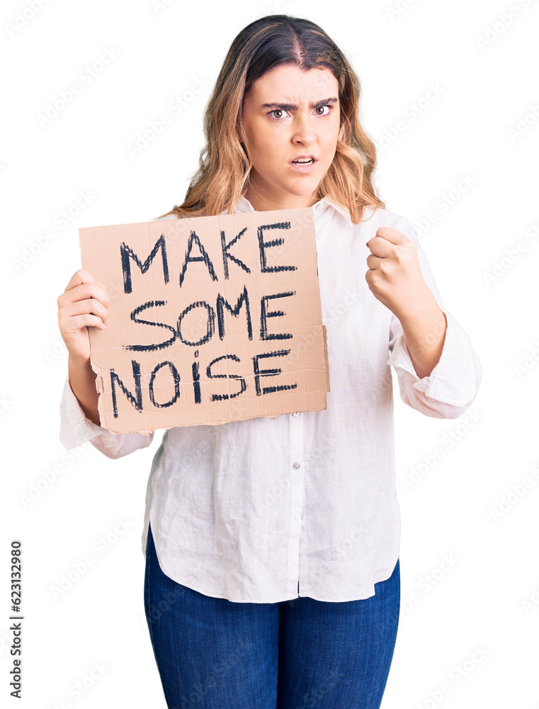 Young caucasian woman holding make some noise banner annoyed and frustrated shouting with anger, yelling crazy with anger and hand raised Young caucasian woman holding make some noise banner annoyed and frustrated shouting with anger, yelling crazy with anger and hand raised