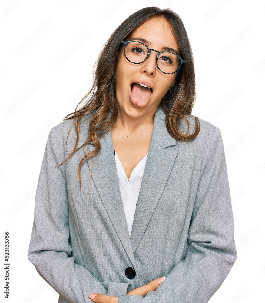 Young brunette woman wearing business clothes sticking tongue out happy with funny expression. emotion concept. Young brunette woman wearing business clothes sticking tongue out happy with funny expression. emotion concept.