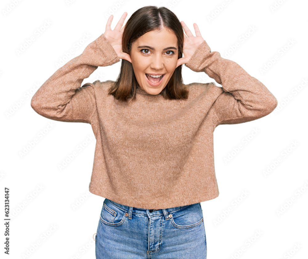 Young beautiful woman wearing casual clothes smiling cheerful playing peek a boo with hands showing face. surprised and exited Young beautiful woman wearing casual clothes smiling cheerful playing peek a boo with hands showing face. surprised and exited
