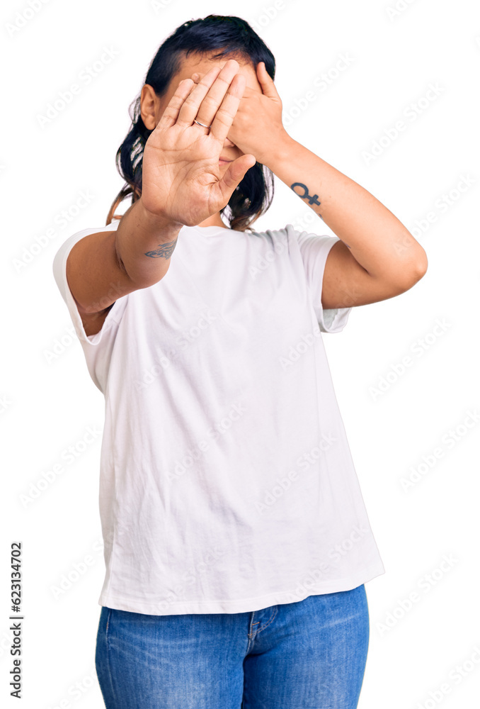Young woman wearing casual clothes covering eyes with hands and doing stop gesture with sad and fear expression. embarrassed and negative concept. Young woman wearing casual clothes covering eyes with hands and doing stop gesture with sad and fear expression. embarrassed and negative concept.