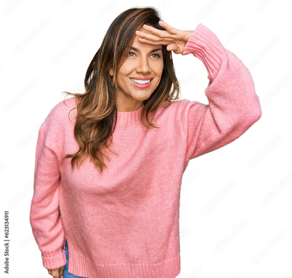 Young hispanic woman wearing casual clothes very happy and smiling looking far away with hand over head. searching concept. Young hispanic woman wearing casual clothes very happy and smiling looking far away with hand over head. searching concept.