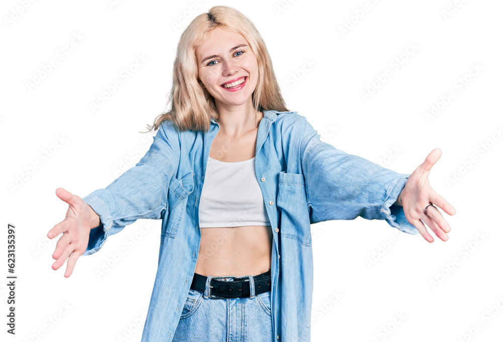 Young caucasian woman wearing casual clothes looking at the camera smiling with open arms for hug. cheerful expression embracing happiness. Young caucasian woman wearing casual clothes looking at the camera smiling with open arms for hug. cheerful expression embracing happiness.