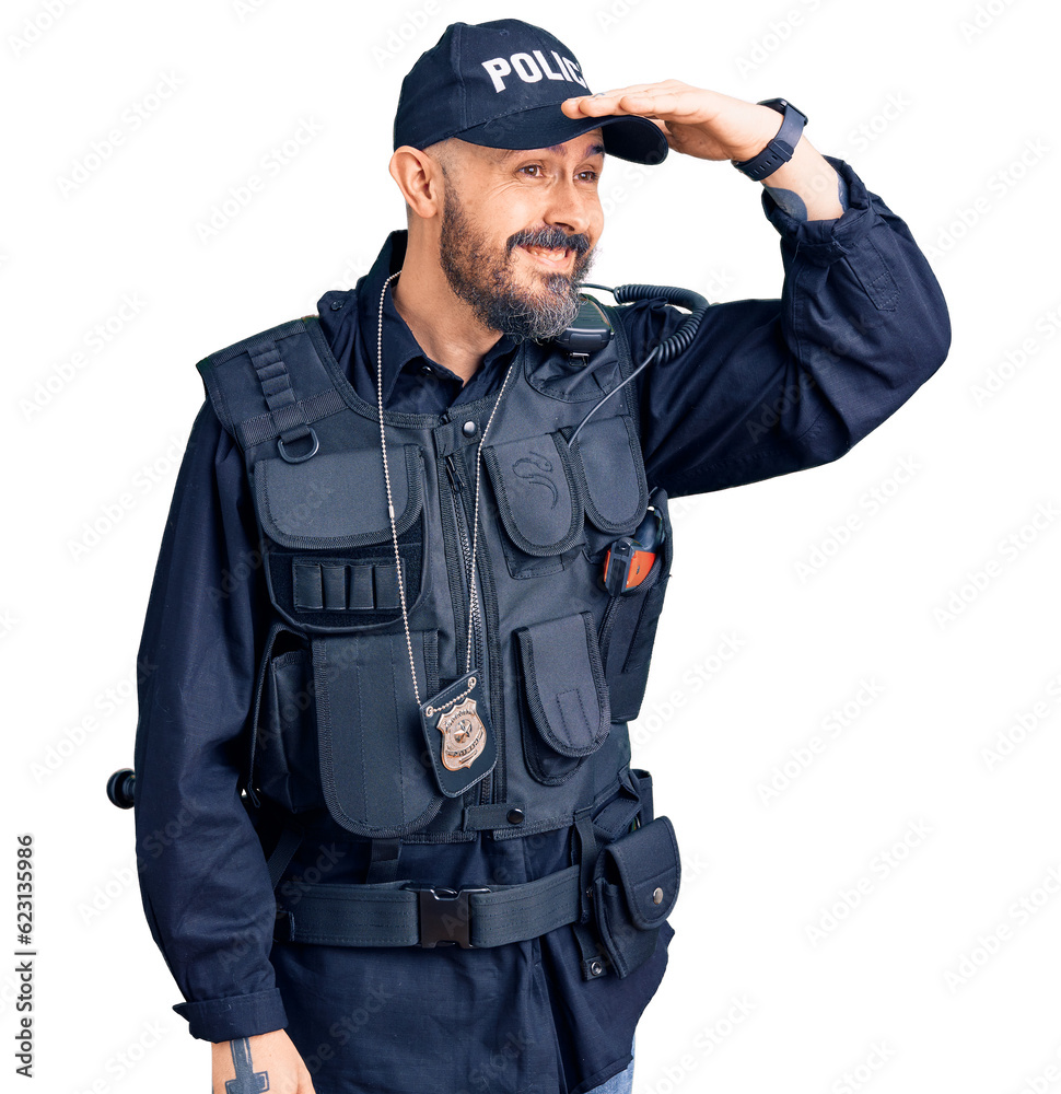 Young handsome man wearing police uniform very happy and smiling looking far away with hand over head. searching concept. Young handsome man wearing police uniform very happy and smiling looking far away with hand over head. searching concept.
