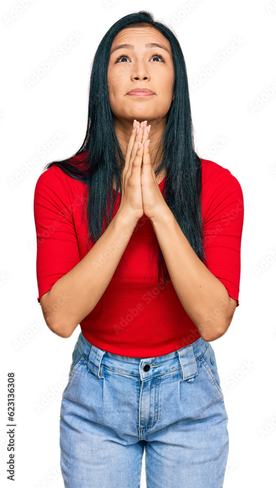 Beautiful hispanic woman wearing casual clothes begging and praying with hands together with hope expression on face very emotional and worried. begging. Beautiful hispanic woman wearing casual clothes begging and praying with hands together with hope expression on face very emotional and worried. begging.