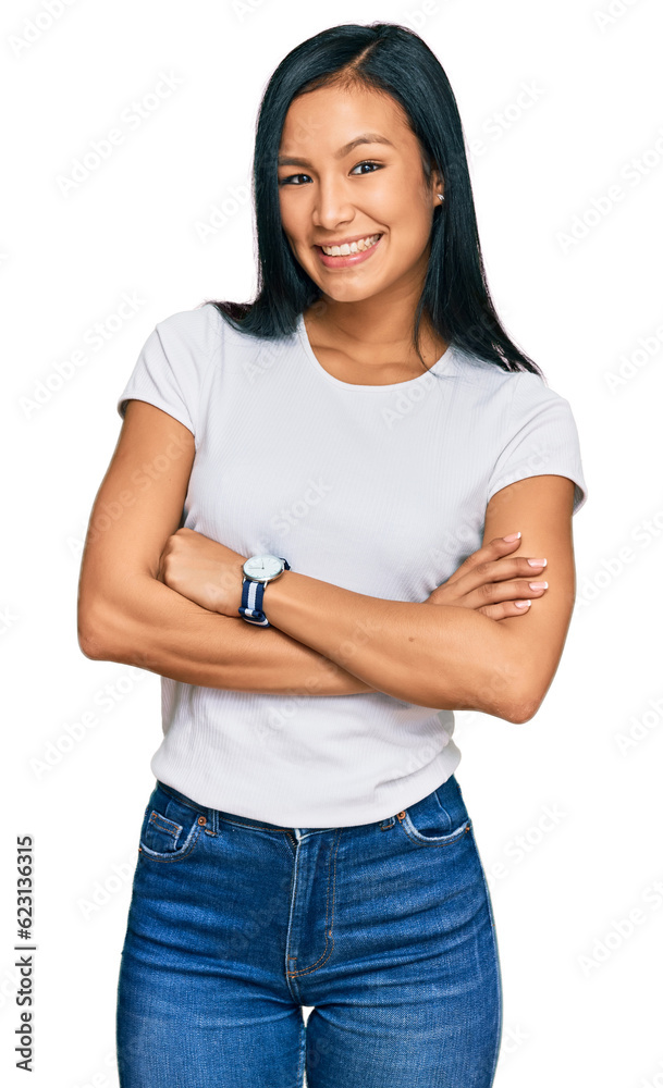 Beautiful hispanic woman wearing casual white tshirt happy face smiling with crossed arms looking at the camera. positive person. Beautiful hispanic woman wearing casual white tshirt happy face smiling with crossed arms looking at the camera. positive person.