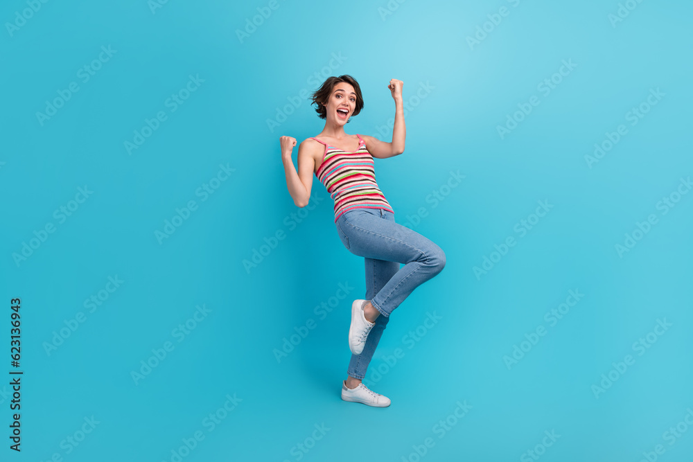 Full length portrait of overjoyed glad person raise fists luck triumph accomplishment isolated on blue color background