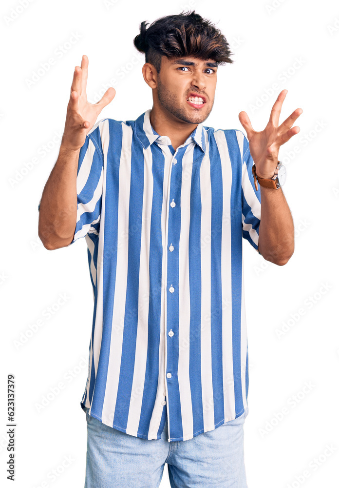 Young hispanic man wearing casual clothes shouting frustrated with rage, hands trying to strangle, yelling mad Young hispanic man wearing casual clothes shouting frustrated with rage, hands trying to strangle, yelling mad