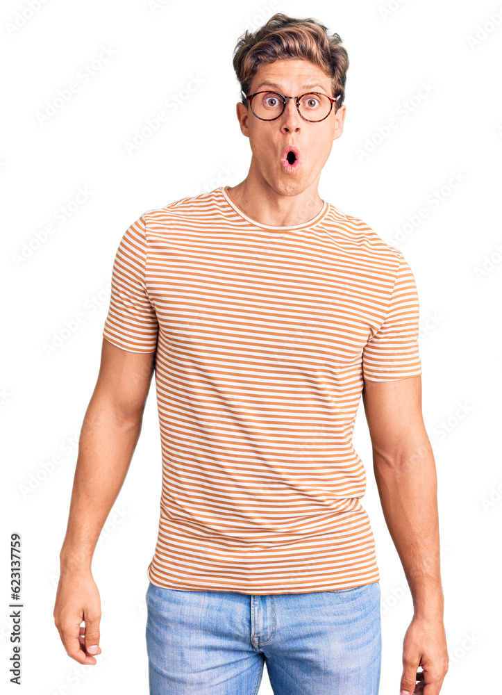 Young handsome man wearing casual clothes and glasses afraid and shocked with surprise expression, fear and excited face. Young handsome man wearing casual clothes and glasses afraid and shocked with surprise expression, fear and excited face.