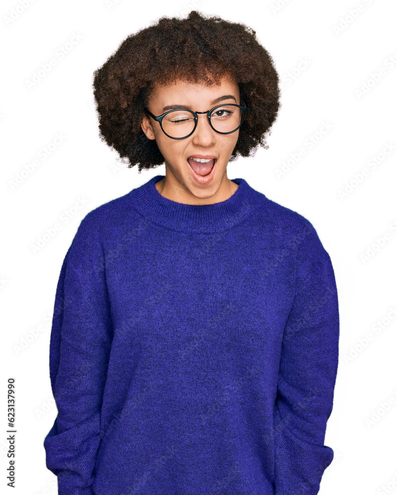 Young hispanic girl wearing casual winter sweater and glasses winking looking at the camera with sexy expression, cheerful and happy face. Young hispanic girl wearing casual winter sweater and glasses winking looking at the camera with sexy expression, cheerful and happy face.