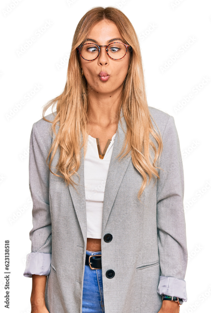 Beautiful blonde young woman wearing business clothes making fish face with lips, crazy and comical gesture. funny expression. Beautiful blonde young woman wearing business clothes making fish face with lips, crazy and comical gesture. funny expression.