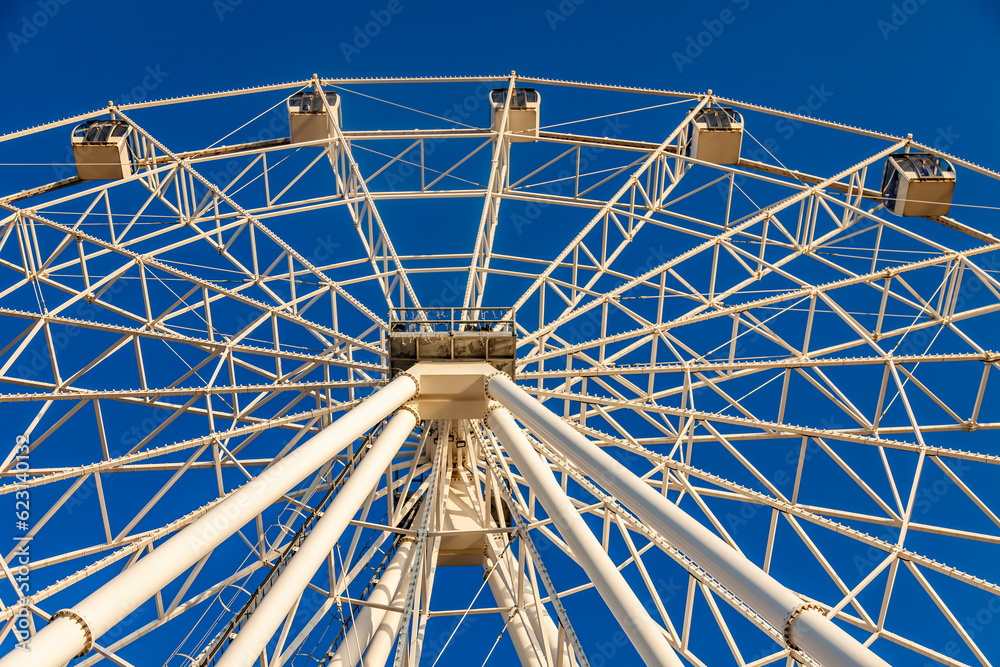 Fototapeta premium Fragment of Ferris wheel against the sunset sky