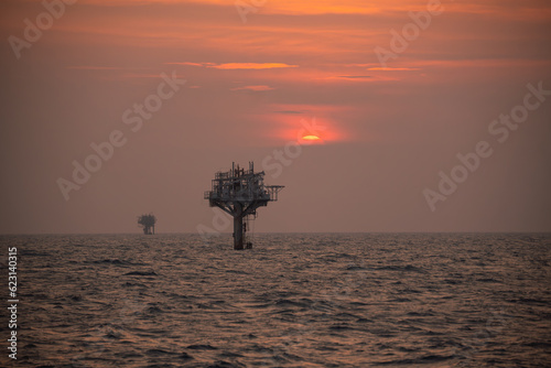 old monopod platform opr oil rig during sunset photo