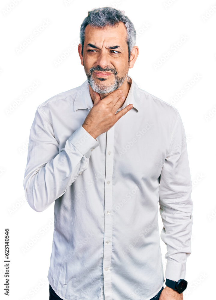 Middle age hispanic with grey hair wearing casual white shirt touching painful neck, sore throat for flu, clod and infection Middle age hispanic with grey hair wearing casual white shirt touching painful neck, sore throat for flu, clod and infection