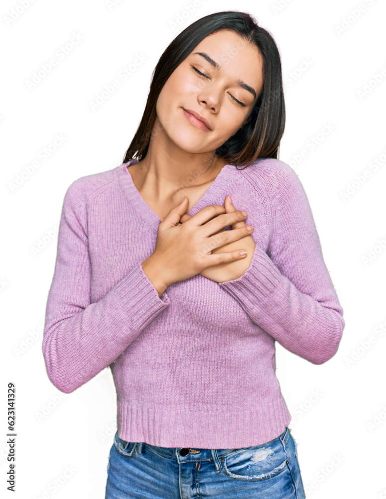 Young hispanic girl wearing casual clothes smiling with hands on chest with closed eyes and grateful gesture on face. health concept. Young hispanic girl wearing casual clothes smiling with hands on chest with closed eyes and grateful gesture on face. health concept.