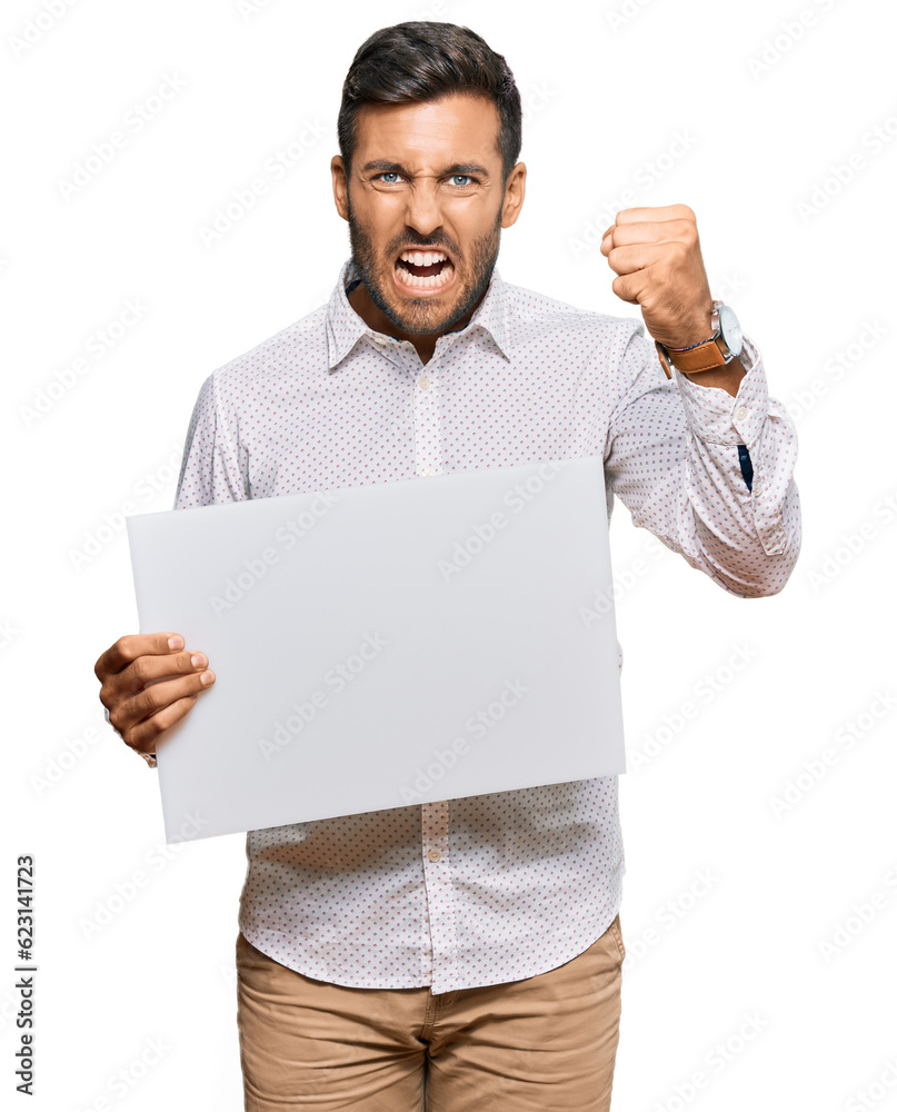 Handsome hispanic man holding blank empty banner annoyed and frustrated shouting with anger, yelling crazy with anger and hand raised Handsome hispanic man holding blank empty banner annoyed and frustrated shouting with anger, yelling crazy with anger and hand raised