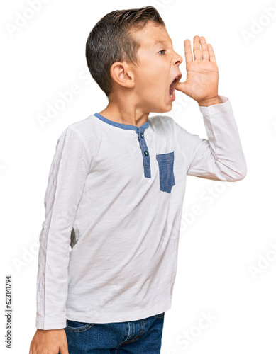 Adorable caucasian kid wearing casual clothes shouting and screaming loud to side with hand on mouth. communication concept.