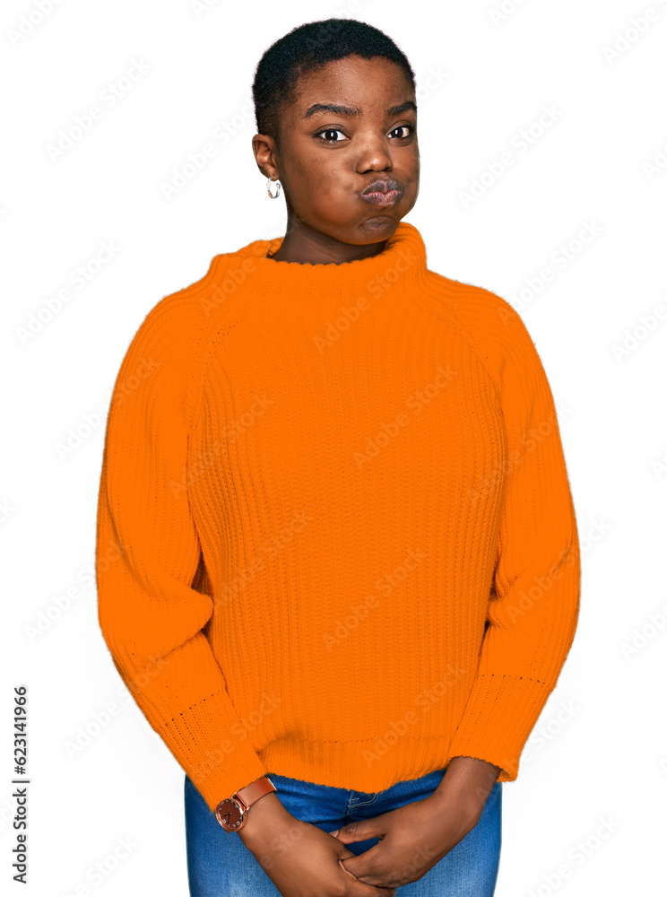 Fototapeta premium Young african american woman wearing casual clothes puffing cheeks with funny face. mouth inflated with air, crazy expression.