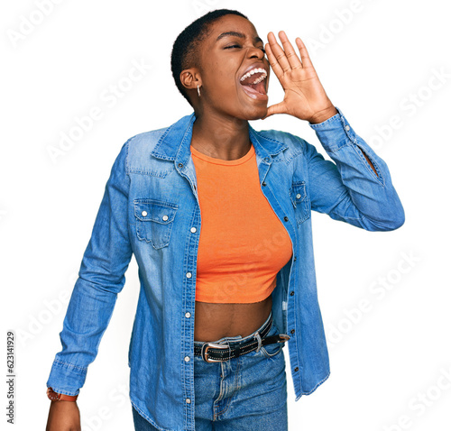 Young african american woman wearing casual clothes shouting and screaming loud to side with hand on mouth. communication concept.