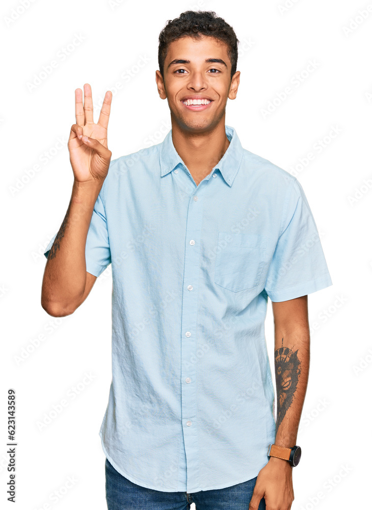 Young handsome african american man wearing casual clothes showing and pointing up with fingers number three while smiling confident and happy. Young handsome african american man wearing casual clothes showing and pointing up with fingers number three while smiling confident and happy.