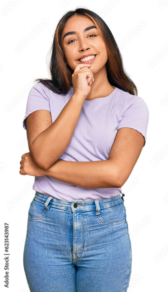 Young latin woman wearing casual clothes looking confident at the camera with smile with crossed arms and hand raised on chin. thinking positive. Young latin woman wearing casual clothes looking confident at the camera with smile with crossed arms and hand raised on chin. thinking positive.