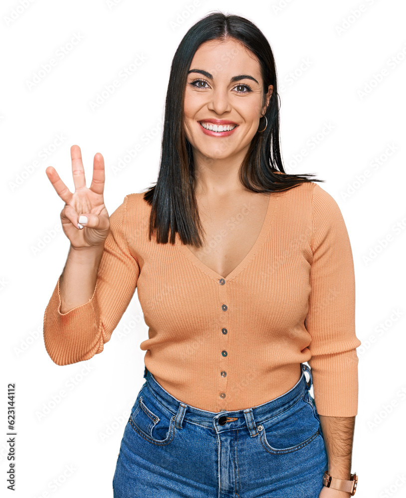 Young hispanic woman wearing casual clothes showing and pointing up with fingers number three while smiling confident and happy. Young hispanic woman wearing casual clothes showing and pointing up with fingers number three while smiling confident and happy.