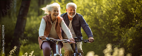 Happy older couple cycling or ride at par and smile
