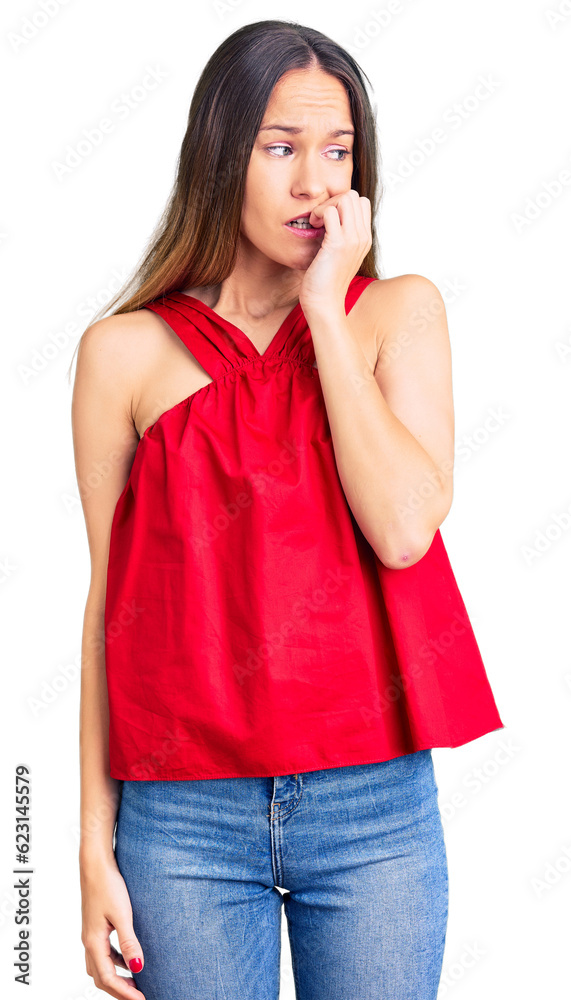 Beautiful brunette young woman wearing casual clothes looking stressed and nervous with hands on mouth biting nails. anxiety problem.