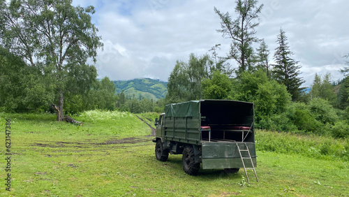 A truck for dropping off tourists to the beginning of the hike - climbing Mount Belukha. Beautiful summer landscape. © chekart