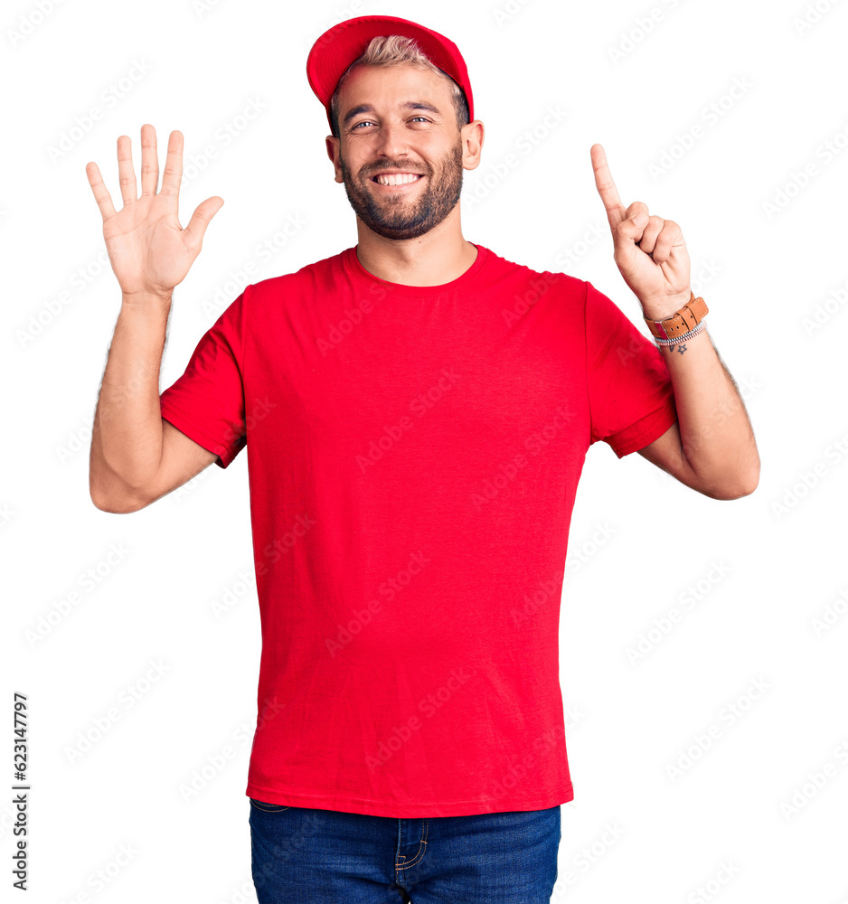 Young handsome blond man wearing t-shirt and cap showing and pointing up with fingers number six while smiling confident and happy. Young handsome blond man wearing t-shirt and cap showing and pointing up with fingers number six while smiling confident and happy.